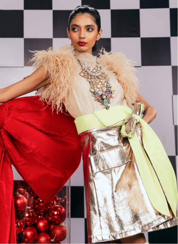 BEIGE OSTRICH FEATHER EMBELLISHED TOP PAIRED WITH A METALLIC OVERLAP SKIRT