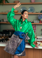 AN EMERALD GREEN TAFETTA SHIRT PAIRED WITH AN ANIMAL PRINT LEATHER OVERLAP SKIRT