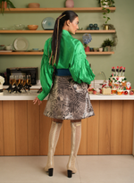 Load image into Gallery viewer, AN EMERALD GREEN TAFETTA SHIRT PAIRED WITH AN ANIMAL PRINT LEATHER OVERLAP SKIRT